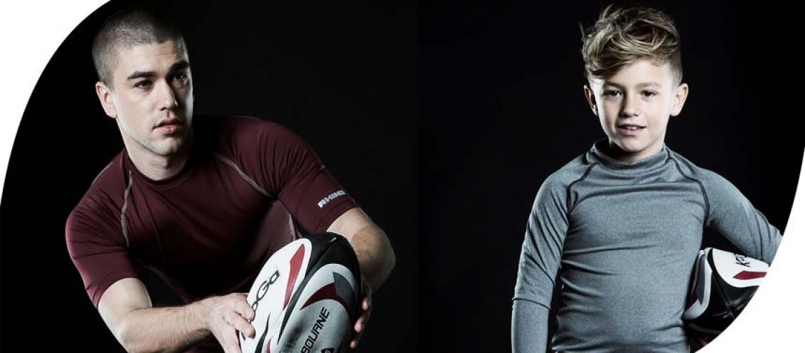a man and a boy holding a rugby ball